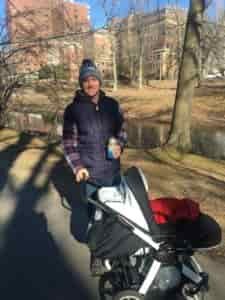 joel pushing in nephew in a stroller in a park